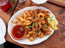 The Daily Catch signature dishes Black Pasta Aglio Olio with Calamari, Monkfish Marsala, Lobster Fra Diavolo, Fried Calamari